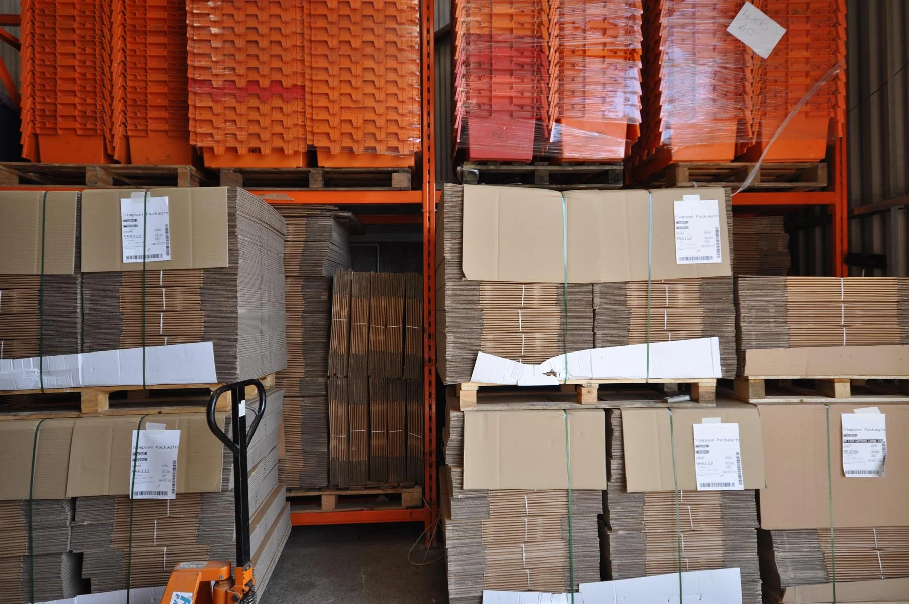Warehouse stock of flat-packed moving cartons and reusable crates